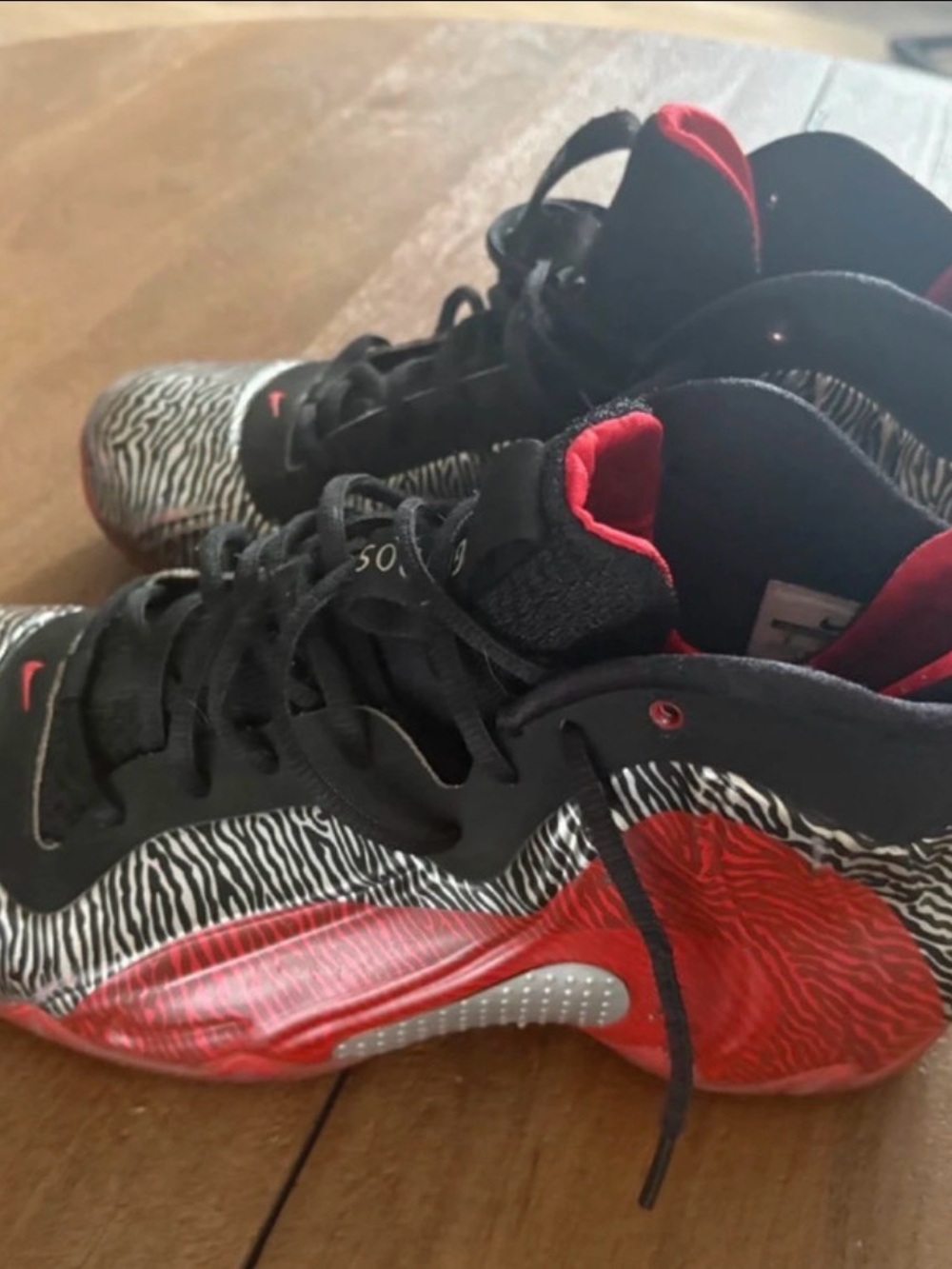Nike Men’s Black, Red and White Zebra-Accent Foamposite Sneakers